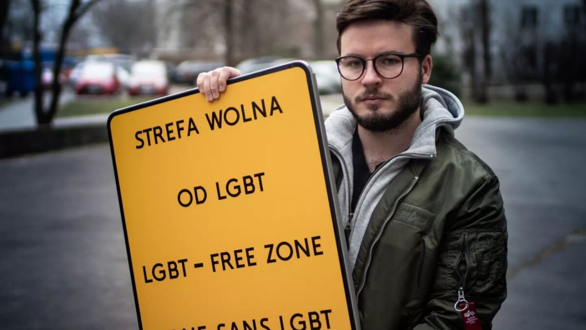 El activista polaco Bartosz Staszewski, con un cartel retirado.