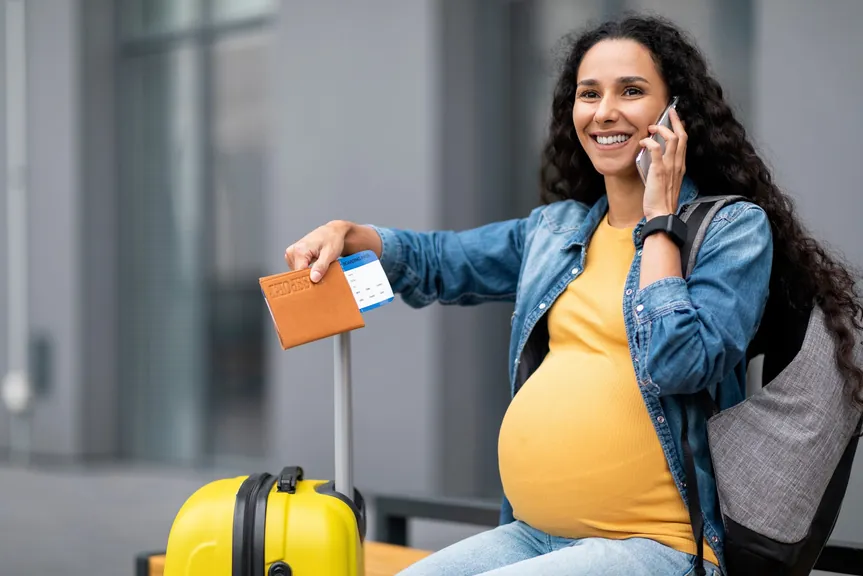 Una embarazada con su pasaporte y tarjeta de embarque